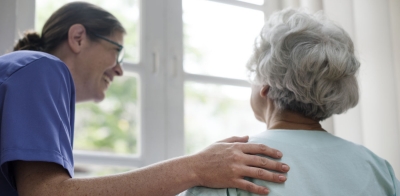 Nurse taking care of an old woman